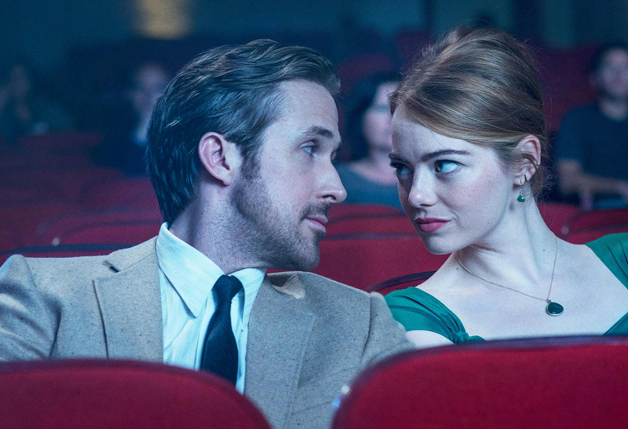 Los actores Ryan Gosling y Emma Stone se miran en el patio de butacas de un cine durante una escena de 'La La Land'