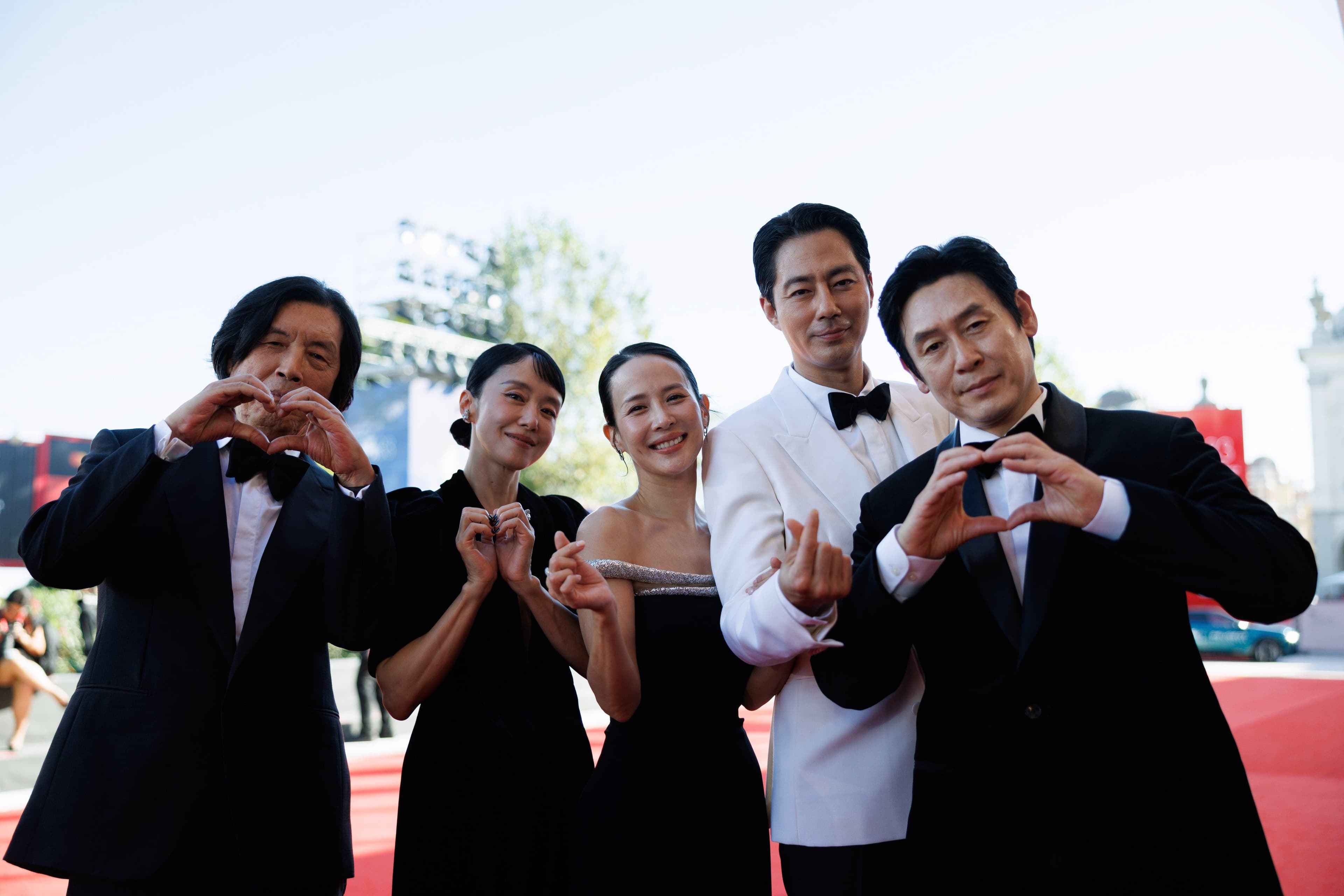 El director surcoreano Lee Chang-dong (d) posa en la alfombra roja del Festival de Venecia junto al reparto de 'Possible Love'