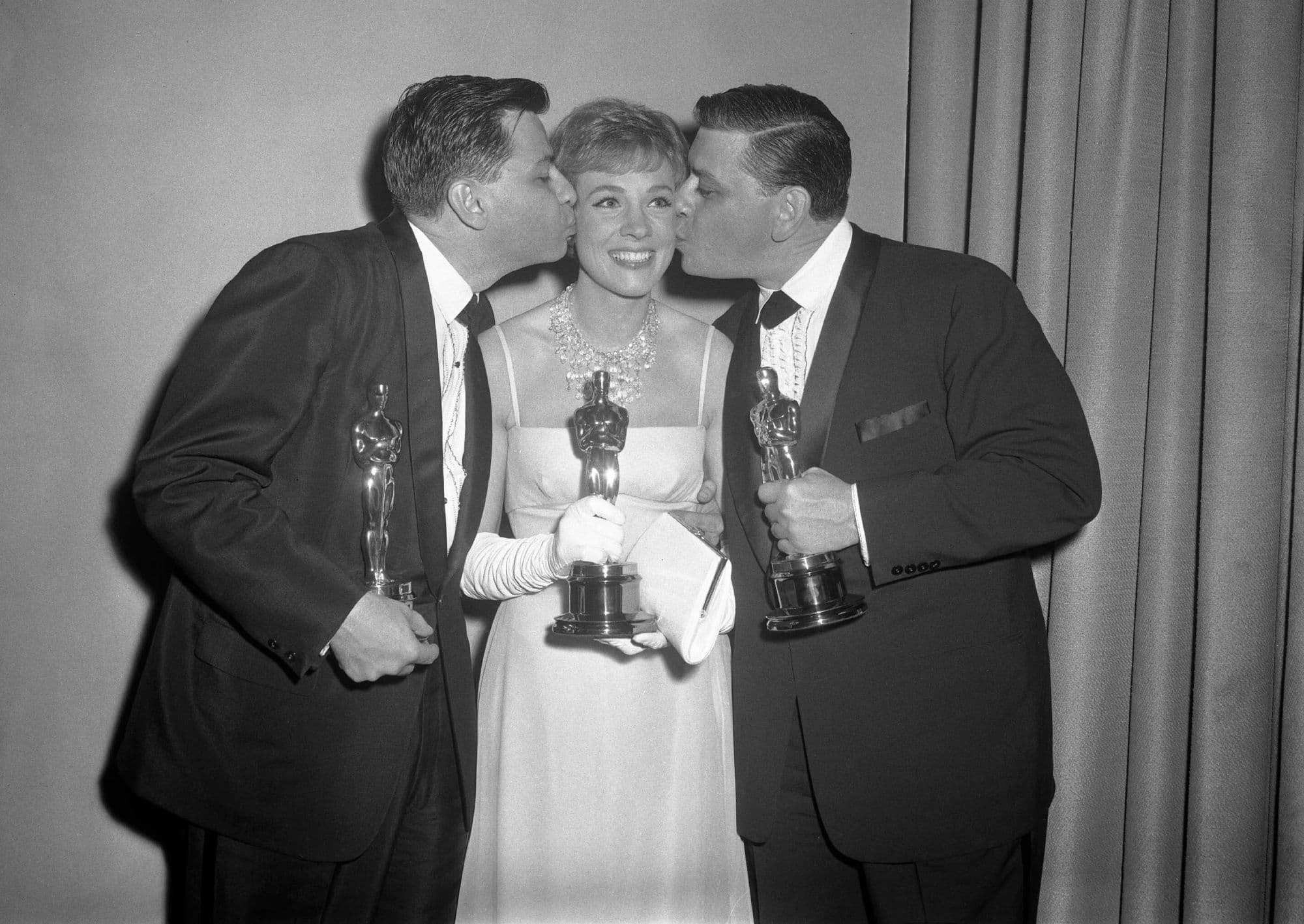 Los compositores Richard y Robert Sherman y la actriz Julie Andrews posan con los Oscar ganados por 'Mary Poppins'