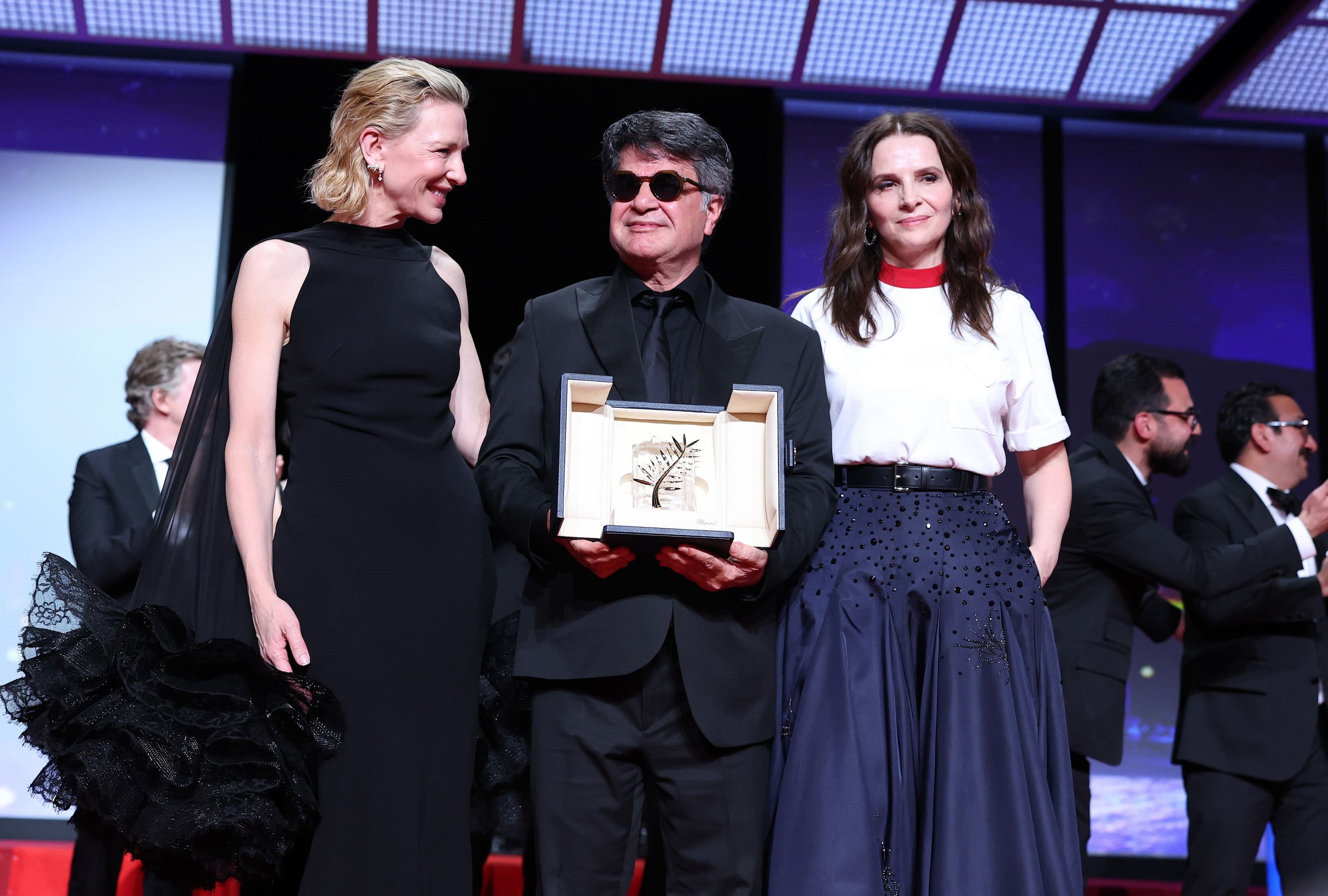 Las actrices Cate Blanchett y Juliette Binoche rodean a Jafar Panahi, que sostiene la Palma de Oro de Cannes 2025 por 'Un simple accidente'